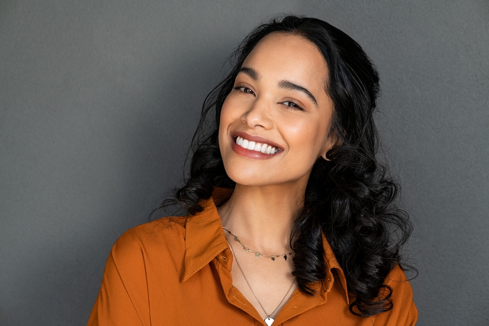 A confident woman smiles beautifully, showing off her brilliant white teeth. You can achieve a similarly radiant smile with professional At Home Teeth Whitening in Spokane Valley